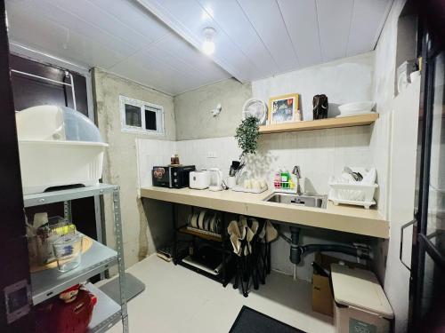 a small kitchen with a counter and a sink at H&K Partner Guest House 
