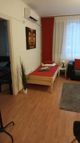 a bedroom with a bed with a mask on the wall at Goldapartman Salgótarján in Salgótarján