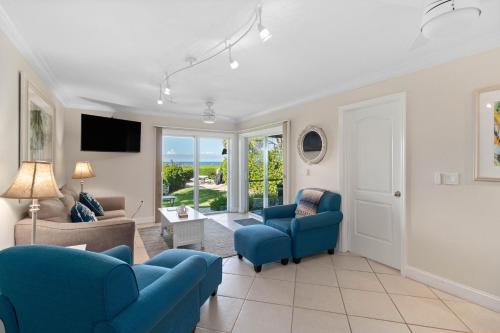 a living room with a blue couch and chairs at Beach Castle Resort #3 in Longboat Key