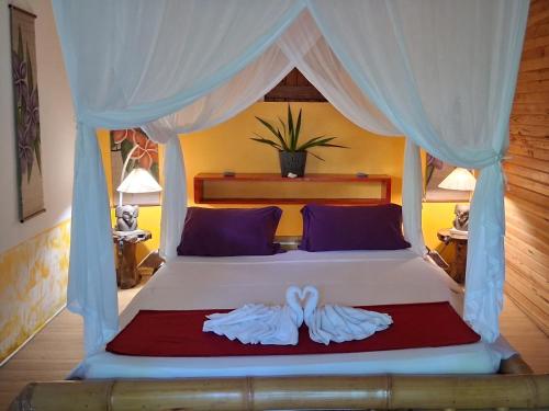 Ένα ή περισσότερα κρεβάτια σε δωμάτιο στο Bungalow atypique Ti Bambou à 500m de la plage