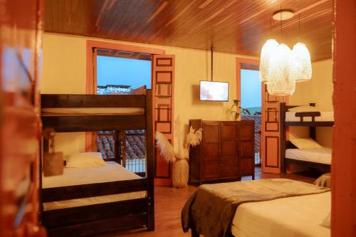 a bedroom with two bunk beds and a balcony at Hotel Colonial Abejorral in Abejorral