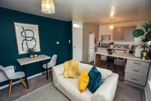 a living room with a couch and a kitchen at Cosy Apartments for Couples & Working Professionals Free Parking & Smart TV in Derby