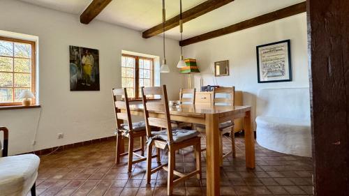 a dining room with a wooden table and chairs at Alte Kate in Hobstin