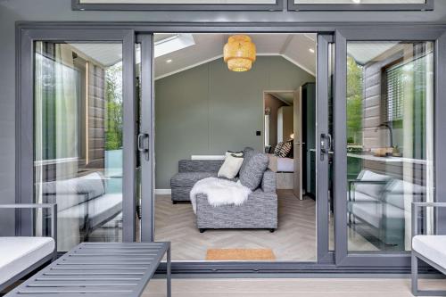 a living room with a couch and a chair at Landal Bryn Morfydd in Llanrhaiadr