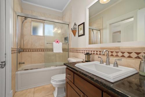 a bathroom with a sink and a tub and a toilet at Princeville/Hanalei Lux 4BR 3.5Ba w/AC+CAR in Princeville
