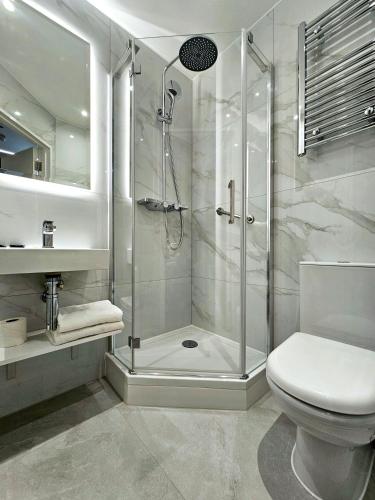 a bathroom with a shower and a toilet at NOX Earls Court in London