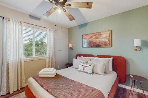 Un dormitorio con una cama con ventilador de techo. en Tempe Comfort Haven, en Tempe