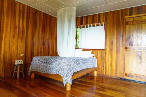 a bedroom with a bed with a curtain on it at Jodokus Inn in Montezuma