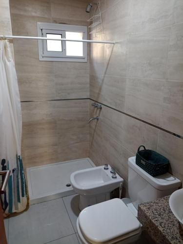 a bathroom with a white toilet and a sink at Monoambiente centrico in Santiago del Estero