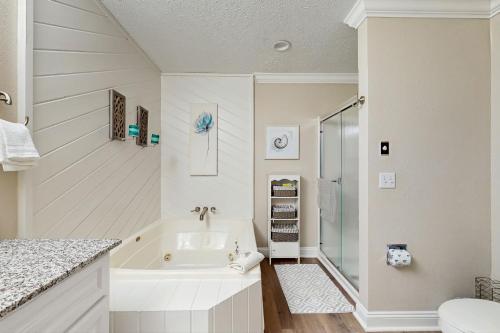 a white bathroom with a tub and a toilet at Trout Creek Condo Resort: Condo 78 in Conway