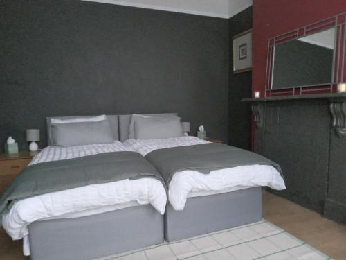 a bedroom with a large bed with white sheets at Honor in London