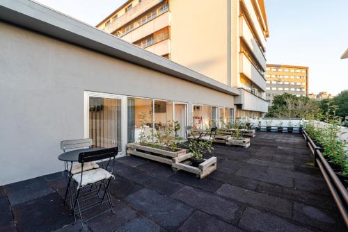 a balcony of a building with a table and chairs at Bom Sucesso Executive Suites by HostWise in Porto