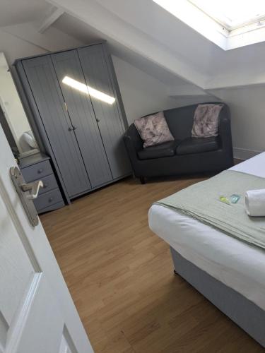 a small room with a bed and a couch at Modern Studio Close to City Centre in Newcastle upon Tyne