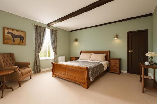 a bedroom with a bed and a chair and a window at Black Horse in Brent Pelham