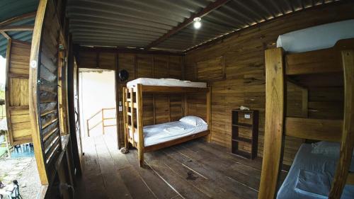 a room with two bunk beds in a cabin at Hotel Paradise in Isla Fuerte