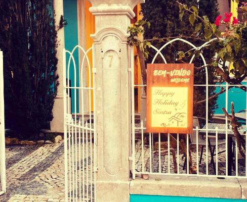 a sign on a gate in front of a building at Happy Holiday Sintra in Sintra