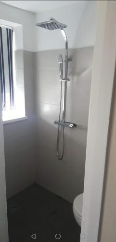 a bathroom with a shower and a toilet at Millhouse Property in Bromborough