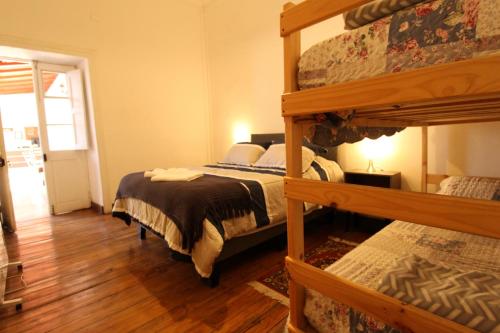 a bedroom with two bunk beds and a wooden floor at Scorpius Hostel in Vicuña
