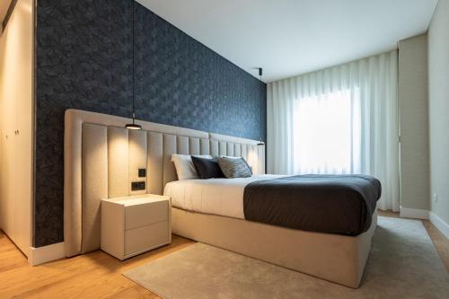 a bedroom with a large bed and a window at Cathedral Houses in Funchal