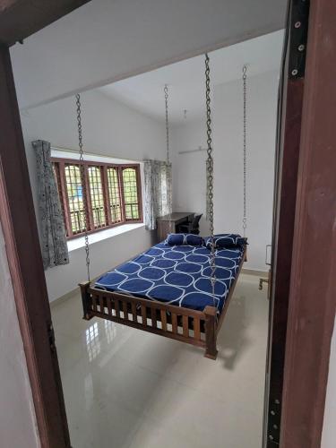 a bedroom with a swing bed in a room at Sankeerthanam - Lounge in serenity in Cochin