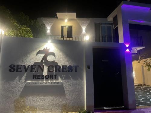 a sign for a seven crest resort at night at Seven Crest Hotel Anuradhapura in Anuradhapura