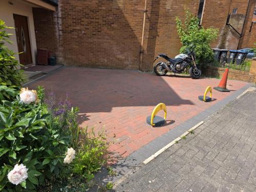 a motorcycle parked in a parking lot with barriers at Wembley Park prime location for Stadium events City break in London