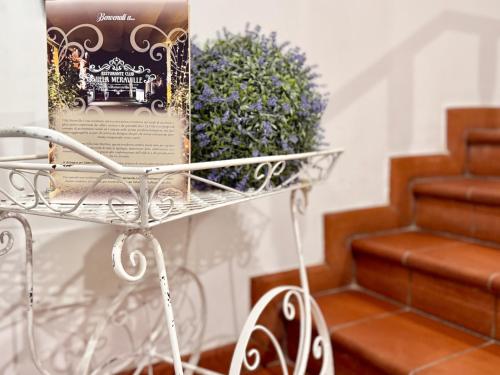 a book sitting on a metal cart next to some stairs at Villa Meraville in Bologna