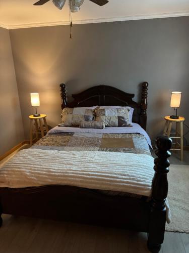 a bedroom with a large bed with two lamps at Fireflies and night skies! in French Lick
