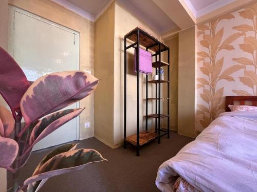 a bedroom with a bed and a room with a window at Bedroom with Balcony and Boudha Stupa View in Kathmandu