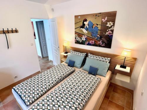 a bedroom with a large bed in a room at Gîte Tango - Les Petites Écuries in Marseillette