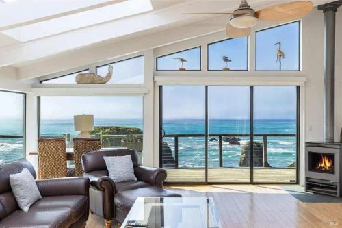 a living room with a view of the ocean at Seaside Elegance Oceanfront Escape with 3 Suites in Bodega Bay