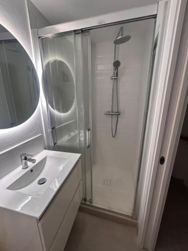 a white bathroom with a shower and a sink at Fabulous 2 bed-townhouse with large rooftop! in Estepona