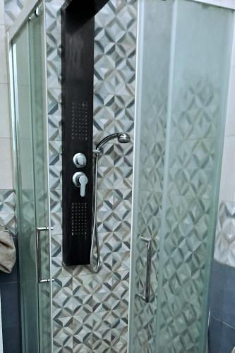 a shower in a bathroom with a glass door at casa adriana in Taranto