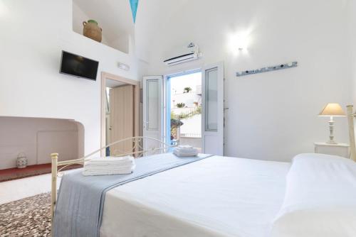 a white bedroom with a bed and a window at B&B Antiche Stelle Salento in Salve