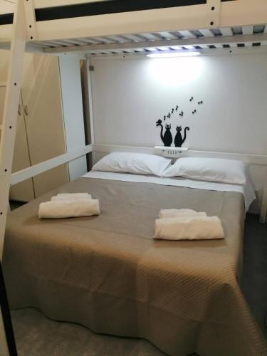 a bedroom with a bed with two pillows on it at casa di Francesco e Azzurra in Torre del Greco