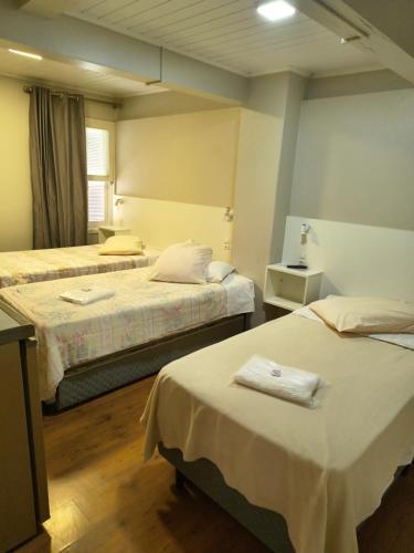 Ένα ή περισσότερα κρεβάτια σε δωμάτιο στο Pinheirais Pousada - Nova Prata