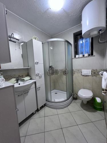 a bathroom with a shower and a toilet and a sink at Adrialana in Porozina