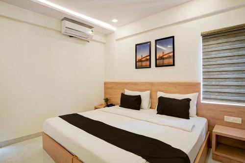 a bedroom with a large bed in a room at Hotel O Mirage Suites in Bengaluru