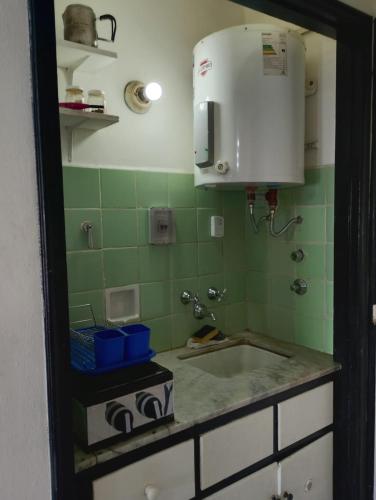 a kitchen with a sink and a microwave at Departamento Casino in Mar del Plata