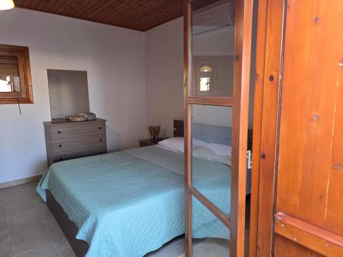 a bedroom with a bed and a wooden cabinet at Fontana Traditional House in Anarita