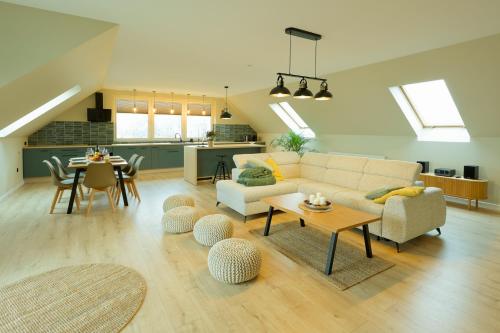 a living room with a couch and a table at Apartament NaWidoki in Sępólno Krajeńskie