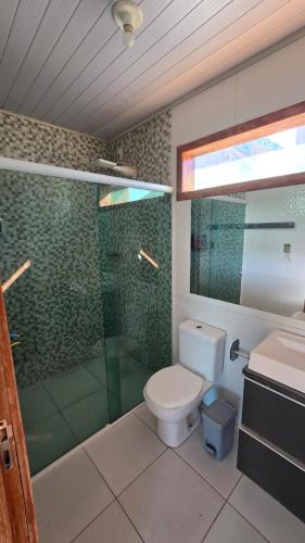 a bathroom with a shower and a toilet and a sink at Karina Saraiva in Palhoça