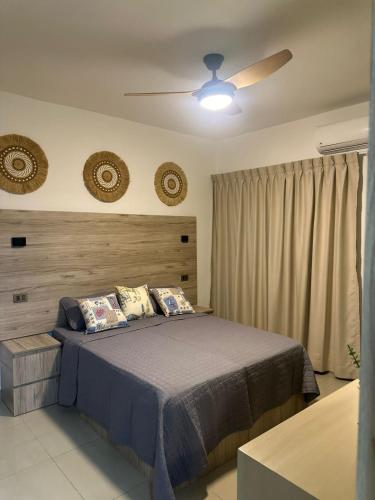 a bedroom with a bed and a ceiling fan at Sol & Arena Bayahibe Apartment in Bayahibe