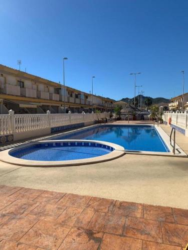 a large swimming pool in the middle of a courtyard at Apartalux Playa Paraíso in La Manga del Mar Menor
