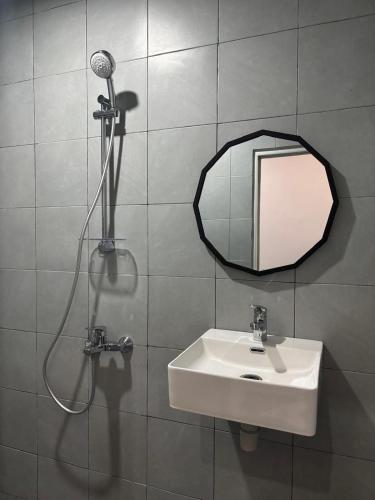a bathroom with a sink and a mirror at Omah Saha at Kraton in Yogyakarta