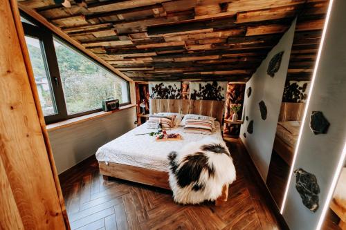 a bedroom with a bed and a large window at StyLove-Apartamenty in Ustroń