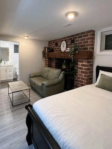 a bedroom with a bed and a brick wall at Modern Newly-Renovated Suite Free Parking in Toronto