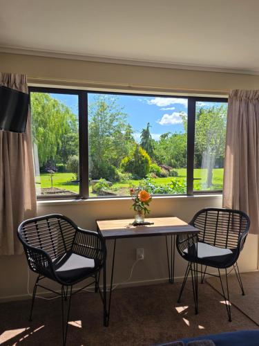 a room with a table and two chairs and a window at Saddleview Cottage-Horse and Trailer friendly in Mosgiel