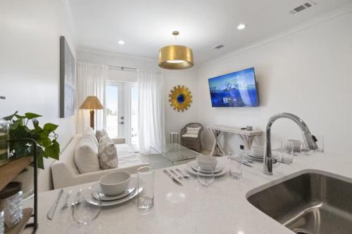 a kitchen and living room with a sink and a couch at Weekend Escape on the Coast-Relax & Unwind in Pass Christian