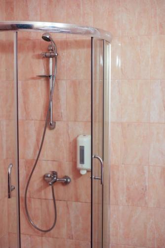 a shower with a shower head in a bathroom at Hotel Poem Calarasi Ballroom in Călăraşi
